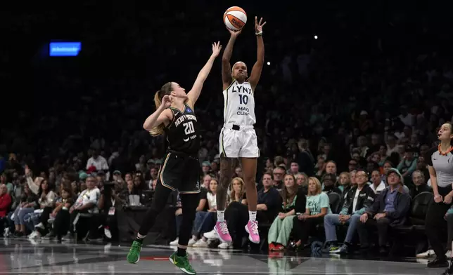 Minnesota Lynx's Courtney Williams (10) shoots against New York Liberty's Sabrina Ionescu (20) during the second half in Game 2 of a WNBA basketball final playoff series, Sunday, Oct. 13, 2024, in New York. (AP Photo/Pamela Smith)