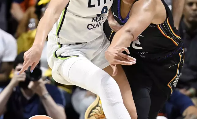 Minnesota Lynx forward Alanna Smith, left, is fouled by Connecticut Sun forward Brionna Jones, right, during the first half of a WNBA basketball semifinal game, Friday, Oct. 4, 2024, in Uncasville, Conn. (AP Photo/Jessica Hill)