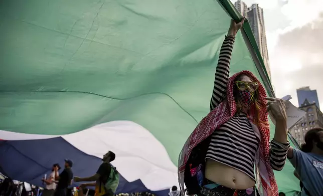 Pro-Palestinian protesters demonstrate outside City Hall, Monday, Oct. 7, 2024, in New York. (AP Photo/Stefan Jeremiah)