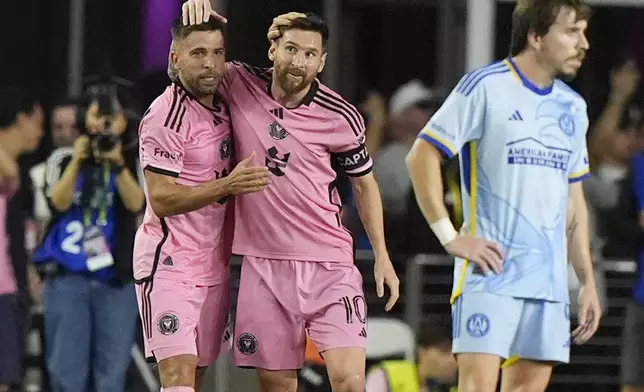 Inter Miami defender Jordi Alba, left, celebrates his goal with forward Lionel Messi (10) during the second half of their MLS playoff opening round soccer match against Atlanta United, Friday, Oct. 25, 2024, in Fort Lauderdale, Fla. (AP Photo/Lynne Sladky)