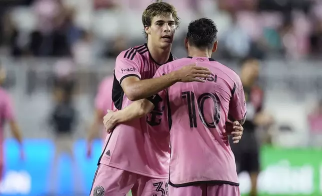 Inter Miami midfielder Benjamin Cremaschi (30) and forward Lionel Messi (10) celebrate at the end of the second half of their MLS playoff opening round soccer match against Atlanta United, Friday, Oct. 25, 2024, in Fort Lauderdale, Fla. (AP Photo/Rebecca Blackwell)