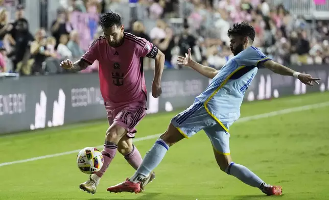 Atlanta United defender Pedro Amador (18) and Inter Miami forward Lionel Messi (10) go after the ball during the second half of their MLS playoff opening round soccer match, Friday, Oct. 25, 2024, in Fort Lauderdale, Fla. (AP Photo/Rebecca Blackwell)