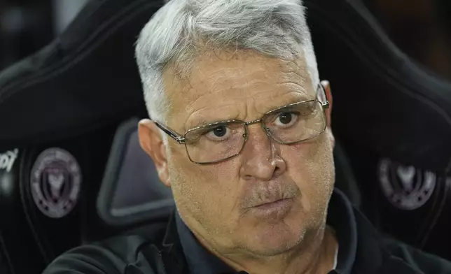 Inter Miami head coach Gerardo "Tata" Martino sits on the bench at the start of an MLS soccer match against Charlotte FC, Saturday, Sept. 28, 2024, in Fort Lauderdale, Fla. (AP Photo/Rebecca Blackwell)