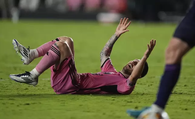 Inter Miami forward Lionel Messi reacts after falling in a clash with defenders, during the second half of an MLS soccer match against Charlotte FC, Saturday, Sept. 28, 2024, in Fort Lauderdale, Fla. (AP Photo/Rebecca Blackwell)