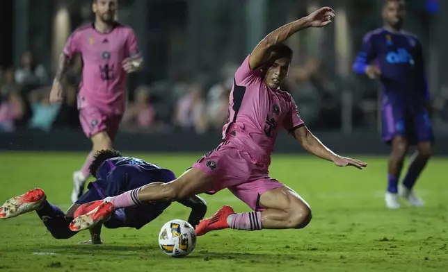 Inter Miami midfielder Diego Gomez (20) is fouled by Charlotte FC defender Adilson Malanda (29), initially drawing a red card but revised to a yellow card on review, during the second half of an MLS soccer match, Saturday, Sept. 28, 2024, in Fort Lauderdale, Fla. (AP Photo/Rebecca Blackwell)