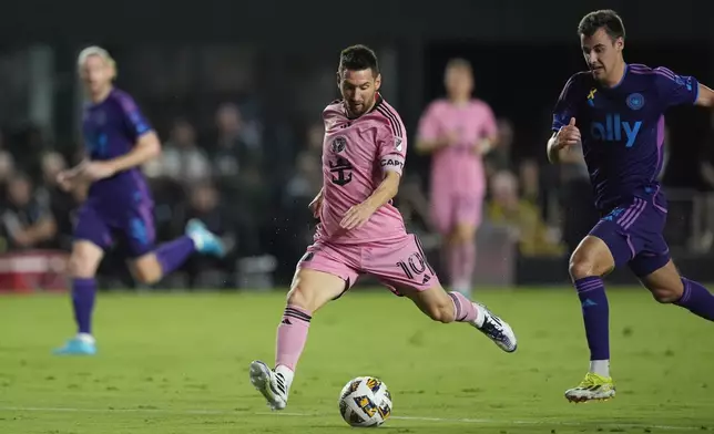 Inter Miami forward Lionel Messi (10) takes a shot, pursued by Charlotte FC midfielder Andrew Privett (34) during the first half of an MLS soccer match, Saturday, Sept. 28, 2024, in Fort Lauderdale, Fla. (AP Photo/Rebecca Blackwell)