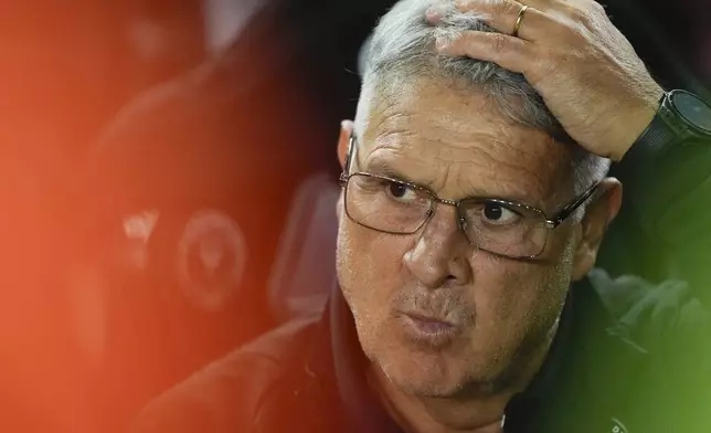 Inter Miami head coach Gerardo "Tata" Martino sits on the bench at the start of an MLS soccer match between Inter Miami and Charlotte FC, Saturday, Sept. 28, 2024, in Fort Lauderdale, Fla. (AP Photo/Rebecca Blackwell)