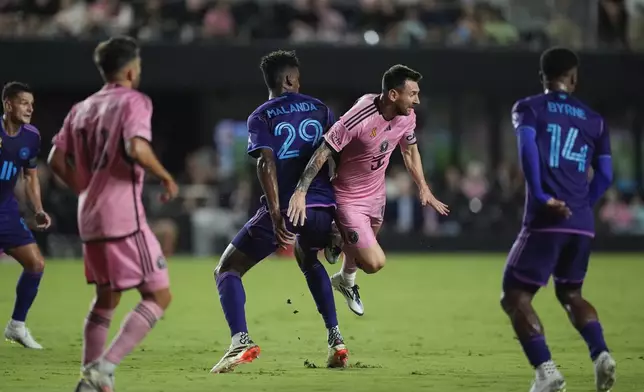 Inter Miami forward Lionel Messi (10) takes a spill as he collides with Charlotte FC defender Adilson Malanda (29) during the first half of an MLS soccer match, Saturday, Sept. 28, 2024, in Fort Lauderdale, Fla. (AP Photo/Rebecca Blackwell)