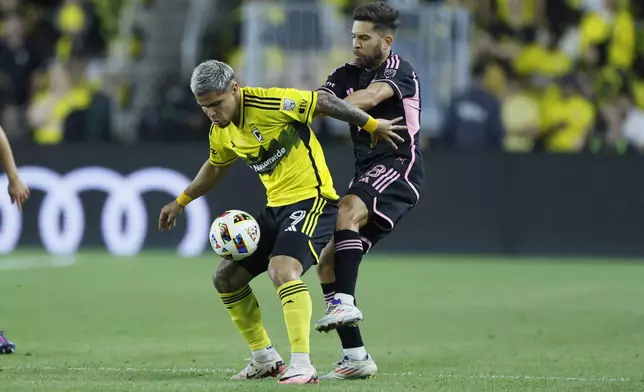 Columbus Crew's Cucho Hernandez, left, keeps the ball away from Inter Miami's Jordi Alba during the first half of an MLS soccer match Wednesday, Oct. 2, 2024, in Columbus, Ohio. (AP Photo/Jay LaPrete)