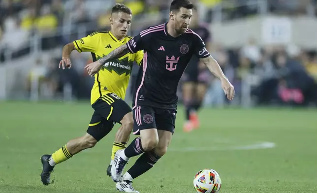 Columbus Crew's Alexandru Matan, left, chases Inter Miami's Lionel Messi during the second half of an MLS soccer match, Wednesday, Oct. 2, 2024, in Columbus, Ohio. (AP Photo/Jay LaPrete)