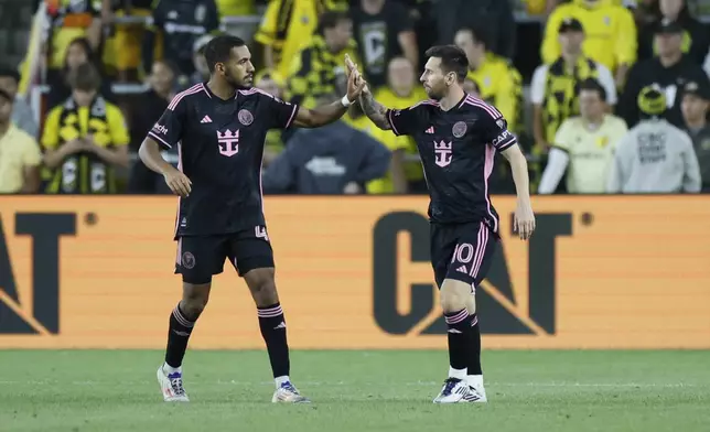 Inter Miami's Yannick Bright, left, and Lionel Messi celebrate their goal against the Columbus Crew during the second half of an MLS soccer match, Wednesday, Oct. 2, 2024, in Columbus, Ohio. (AP Photo/Jay LaPrete)