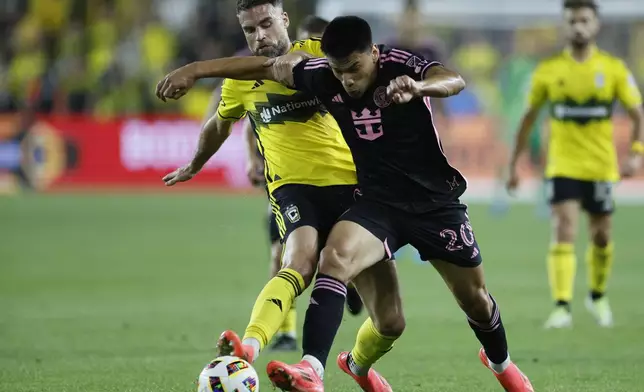 Inter Miami's Diego Gomez, right, and Columbus Crew's Rudy Camacho chase the ball during the first half of an MLS soccer match Wednesday, Oct. 2, 2024, in Columbus, Ohio. (AP Photo/Jay LaPrete)