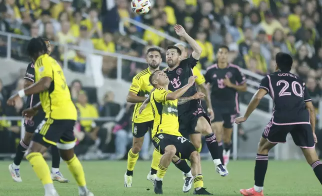 Inter Miami's Lionel Messi, right, and Columbus Crew's Alexandru Matan fight for the ball during the first half of an MLS soccer match Wednesday, Oct. 2, 2024, in Columbus, Ohio. (AP Photo/Jay LaPrete)