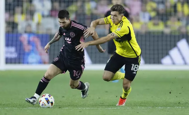 Inter Miami's Lionel Messi, left, and Columbus Crew's Malte Amundsen chase the ball during the second half of an MLS soccer match, Wednesday, Oct. 2, 2024, in Columbus, Ohio. (AP Photo/Jay LaPrete)