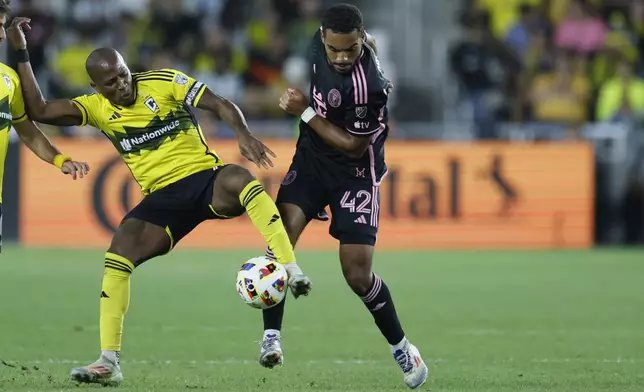 Columbus Crew's Darlington Nagbe, left, tries to kick the ball away from Inter Miami's Yannick Bright during the second half of an MLS soccer match, Wednesday, Oct. 2, 2024, in Columbus, Ohio. (AP Photo/Jay LaPrete)