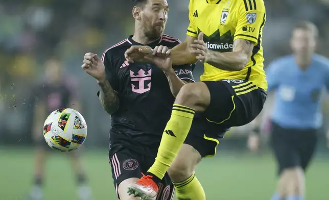 Inter Miami's Lionel Messi, left, collides with Columbus Crew's Malte Amundsen during the second half of an MLS soccer match, Wednesday, Oct. 2, 2024, in Columbus, Ohio. (AP Photo/Jay LaPrete)