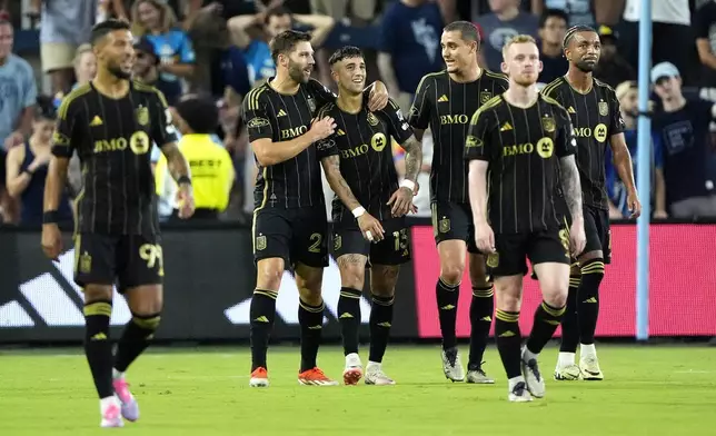 Los Angeles FC attacker Cristian Olivera (13) celebrates with teammates after scoring a goal during the first half of an MLS soccer match against Sporting Kansas City Saturday, Oct. 5, 2024, in Kansas City, Kan. (AP Photo/Charlie Riedel)