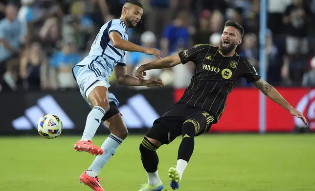 Sporting Kansas City defender Joaquin Fernandez, left, and Los Angeles FC attacker Olivier Giroud (9) battle for the ball during the first half of an MLS soccer match Saturday, Oct. 5, 2024, in Kansas City, Kan. (AP Photo/Charlie Riedel)