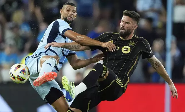 Sporting Kansas City defender Joaquin Fernandez, left, and Los Angeles FC attacker Olivier Giroud (9) battle for the ball during the first half of an MLS soccer match Saturday, Oct. 5, 2024, in Kansas City, Kan. (AP Photo/Charlie Riedel)