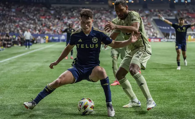 Vancouver Whitecaps' Sebastian Berhalter, left, and Los Angeles FC's Eddie Segura (4) vie for the ball during second half MLS soccer action in Vancouver, British Columbia, Sunday, Oct. 13, 2024. (Ethan Cairns/The Canadian Press via AP)