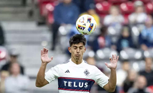 Vancouver Whitecaps' Mathias Laborda heads the ball during the second half of an MLS soccer game against Minnesota United, Saturday, Oct. 5, 2024 in Vancouver, British Columbia. (Ethan Cairns/Canadian Press via AP)