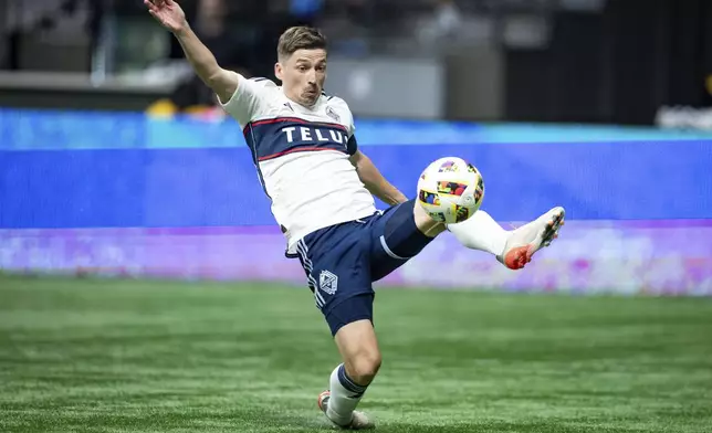 Vancouver Whitecaps' Ryan Gauld (25) kicks the ball missing the net during the second half of an MLS soccer match against Minnesota United in Vancouver, British Columbia. (Ethan Cairns/Canadian Press via AP)