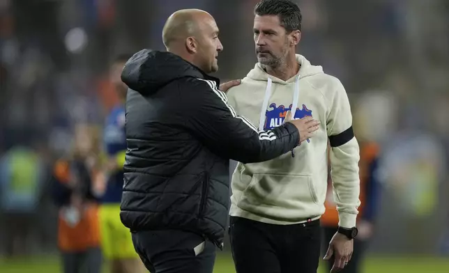 FC Cincinnati head coach Pat Noonan, right, and New York City FC head coach Nick Cushing, left, talk after their first-round soccer match of the MLS Cup playoffs, Monday, Oct. 28, 2024, in Cincinnati. (AP Photo/Carolyn Kaster)