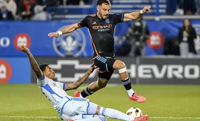 CF Montreal's Jahkeele Marshall-Rutty, left, challenges New York City FC's Kevin O'Toole during first half MLS soccer action in Montreal, Saturday, October 19, 2024. (Graham Hughes/The Canadian Press via AP)