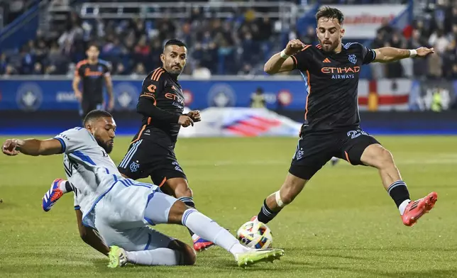 CF Montreal's George Campbell, left, clears the ball as New York City FC's Kevin O'Toole, right, moves in during first half MLS soccer action in Montreal, Saturday, October 19, 2024. (Graham Hughes/The Canadian Press via AP)