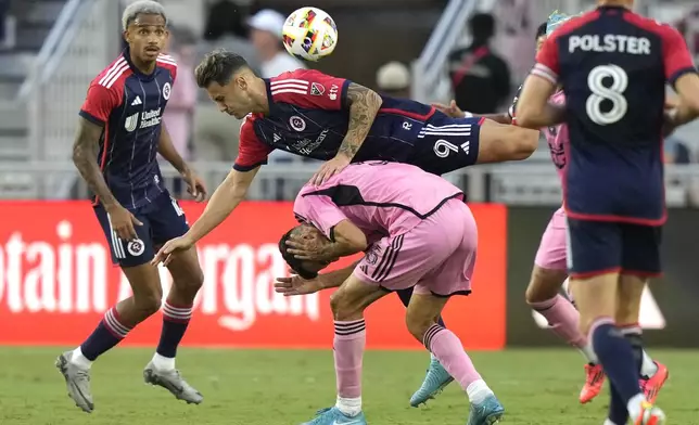 New England Revolution forward Giacomo Vrioni (9) goes for the ball over Inter Miami midfielder Sergio Busquets (5) during the first half of an MLS soccer match, Saturday, Oct. 19, 2024, in Fort Lauderdale, Fla. (AP Photo/Lynne Sladky)