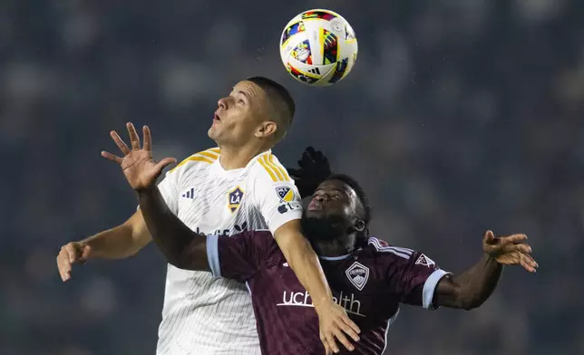 Los Angeles Galaxy forward Dejan Joveljić (9) and Colorado Rapids defender Lalas Abubakar (6) battle for a header during the first half of the first match of an MLS Cup playoffs opening round, Saturday, Oct. 26, 2024, in Carson, Calif. (AP Photo/Kyusung Gong)