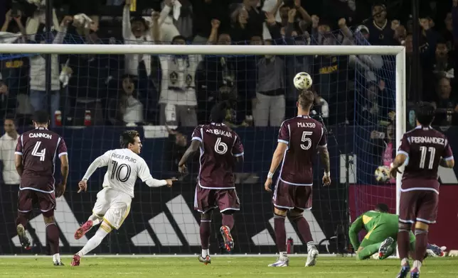 Los Angeles Galaxy midfielder Riqui Puig (10) scores a goal during the second half of the first match of an MLS Cup playoffs opening round against the Colorado Rapids, Saturday, Oct. 26, 2024, in Carson, Calif. (AP Photo/Kyusung Gong)