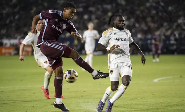 Los Angeles Galaxy forward Joseph Paintsil (28) blocks the shot by Colorado Rapids defender Reggie Cannon (4) during the second half of the first match of an MLS Cup playoffs opening round, Saturday, Oct. 26, 2024, in Carson, Calif. (AP Photo/Kyusung Gong)