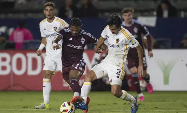 Los Angeles Galaxy defender Miki Yamane (2) takes the ball away from Colorado Rapids forward Kimani Stewart-Baynes (27) during the second half of the first match of an MLS Cup playoffs opening round, Saturday, Oct. 26, 2024, in Carson, Calif. (AP Photo/Kyusung Gong)