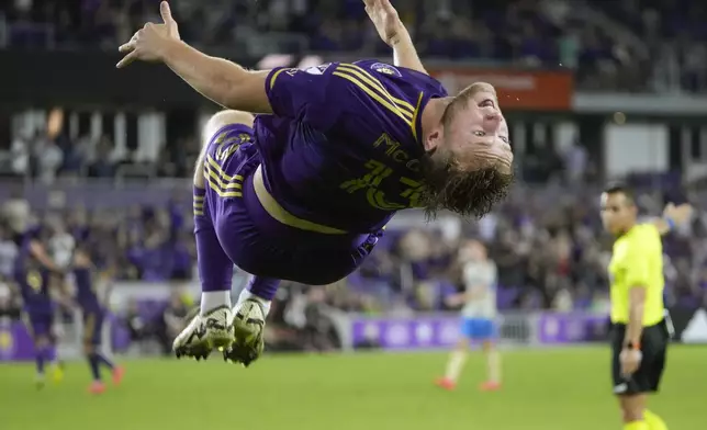 Orlando City's Duncan McGuire does a back flip after scoring a goal against the Philadelphia Union during the second half of an MLS soccer match, Wednesday, Oct. 2, 2024, in Orlando, Fla. (AP Photo/John Raoux)