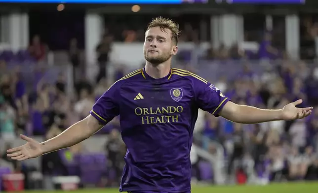 Orlando City's Duncan McGuire celebrates after scoring a goal against the Philadelphia Union during the second half of an MLS soccer match, Wednesday, Oct. 2, 2024, in Orlando, Fla. (AP Photo/John Raoux)