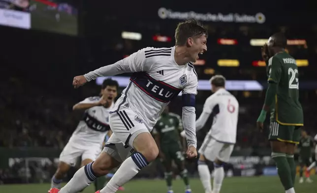 Vancouver Whitecaps midfielder Ryan Gauld scores a goal during the first half of an MLS soccer match against the Portland Timbers Wednesday, Oct. 23, 2024, in Portland, Ore. (AP Photo/Howard Lao)