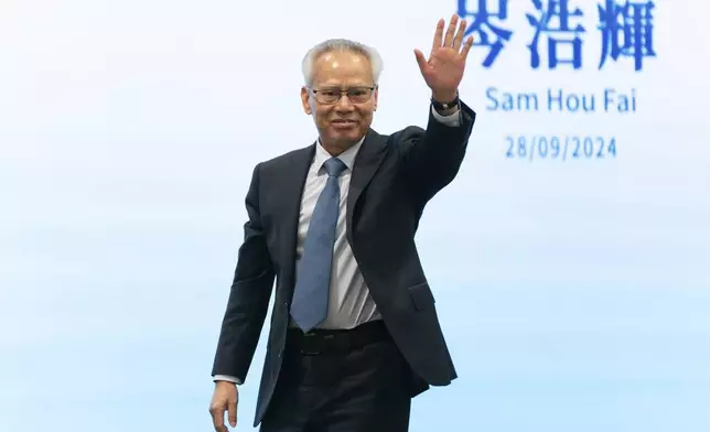 FILE The sole candidate for the upcoming election for the Macao chief executive post, Sam Hou Fai, the city's former top judge, waves as he leaves the stage after a press conference at the China-Portuguese-speaking Countries Commercial and Trade Service Platform Complex in Macao, Saturday, Sept. 28, 2024. (AP Photo/Anthony Kwan, File)