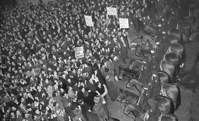 FILE - In this Feb. 20, 1939 file photo, New York City's mounted police form a line outside Madison Square Garden to hold in check a crowd that packed the streets where the German American Bund was holding a rally. (AP Photo/Murray Becker, File)