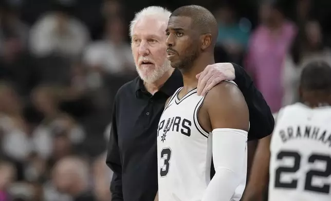 San Antonio Spurs head coach Gregg Popovich, left, talks with guard Chris Paul (3) during the first half of a preseason NBA basketball game against the Orlando Magic in San Antonio, Wednesday, Oct. 9, 2024. (AP Photo/Eric Gay)