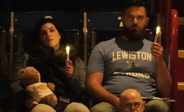 Attendees observe a moment of silence at a commemoration event to mark the one year anniversary of the mass shooting in Lewiston, Maine, Friday, Oct. 25, 2024. (AP Photo/Robert F. Bukaty)