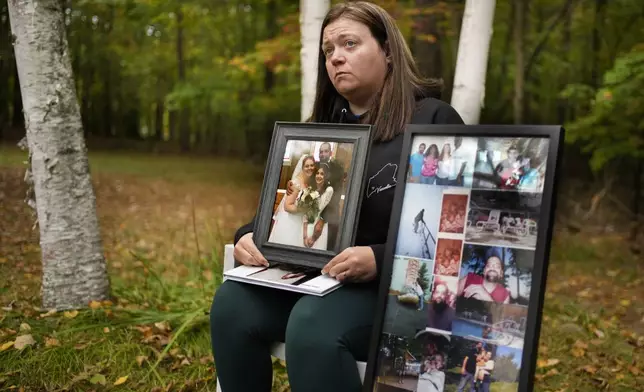 Megan Vozzella shows family photos during an interview about her late husband, Stephen Vozzella, who was one of the people killed in a mass shooting on Oct. 25, 2023, in Lewiston, Tuesday, Oct. 1, 2024, in Oxford, Maine. (AP Photo/Robert F. Bukaty)