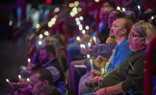 Attendees hold candles at a commemoration event to mark the one year anniversary of the mass shooting in Lewiston, Maine, Friday, Oct. 25, 2024. (Andree Kehn/Sun Journal via AP)