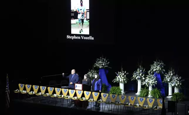 Empty chairs stand for each of the 18 victims as their names are read out loud at a commemoration event to mark the one year anniversary of the mass shooting in Lewiston, Maine, Friday, Oct. 25, 2024. (AP Photo/Robert F. Bukaty)