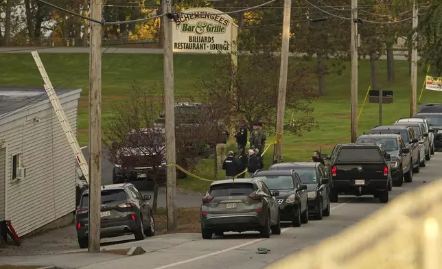 FILE - Law enforcement gather outside Schemengee's Bar and Grille, Thursday, Oct. 26, 2023, in Lewiston, Maine. (AP Photo/Robert F. Bukaty, File)