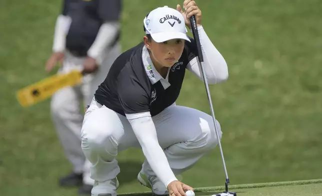 Yin Ruoning of China lines up a putt on on the 17th hole during the LPGA Tour's Maybank Championship at Kuala Lumpur Golf and Country club in Kuala Lumpur, Sunday, Oct. 27, 2024. (AP Photo/Vincent Thian)