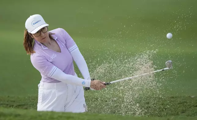 Marina Alex of the United States hits from a fairway bunker at the 3rd fairway during the first round of Maybank LPGA Championship golf tournament at Kuala Lumpur Golf and Country club in Kuala Lumpur, Thursday, Oct. 24, 2024. (AP Photo/Vincent Thian)