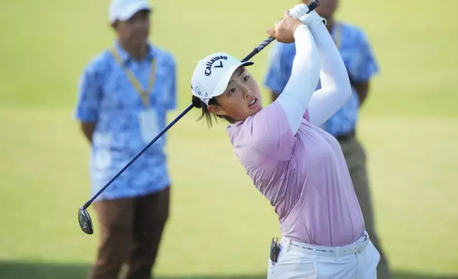 Ruoning Yin of China's watches her fairway shot on the third hole during the second round of Maybank LPGA Championship golf tournament at Kuala Lumpur Golf and Country club in Kuala Lumpur, Thursday, Oct. 24, 2024. (AP Photo/Vincent Thian)