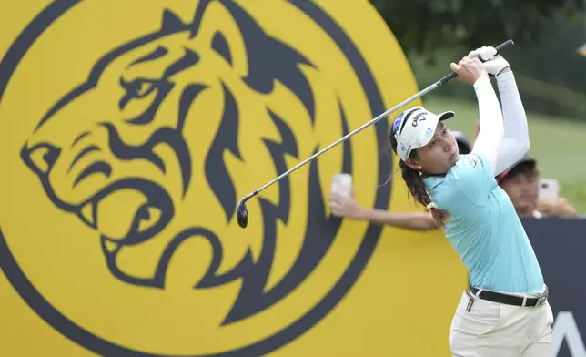 Jean Thitikul of Thailand, watches her tee shot on the 16th hole during the LPGA Tour's Maybank Championship at Kuala Lumpur Golf and Country club in Kuala Lumpur, Sunday, Oct. 27, 2024. (AP Photo/Vincent Thian)