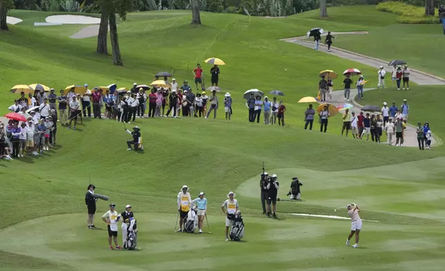 Ryu Haeran of South Korea's, right, watches her fairway shot on the 14th hole during the LPGA Tour's Maybank Championship at Kuala Lumpur Golf and Country club in Kuala Lumpur, Sunday, Oct. 27, 2024. (AP Photo/Vincent Thian)